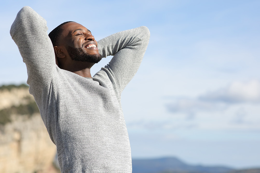 Relieved smiling man outdoors